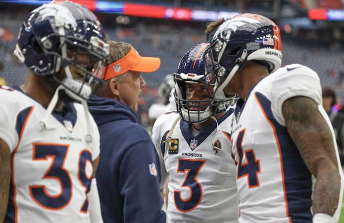 Denver Broncos head coach Sean Payton talks to Denver Broncos quarterback Russell Wilson (3) before playing against Houston Texans at NRG Stadium.